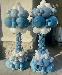 two tall blue and white balloons on top of each other