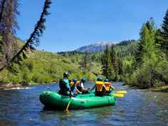 four people in an inflatable raft on a river