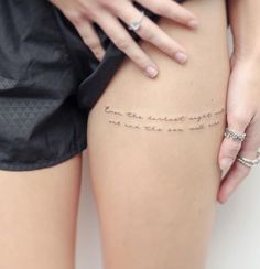 a woman's thigh with writing on it and her hand resting on the thighs