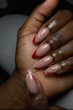 Almond Shape French Tip With Design, Nail Inspo Red French Tip, Winter Nail Designs Red, Holiday Classy Nails, Holiday Almond Nails Christmas, Winter Oval Nails, Red Tip Almond Nails, Red Blooming Gel Nails, French Tip Nails Holiday