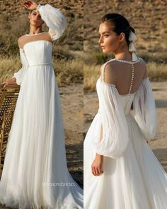 a woman in a white wedding dress standing next to another woman wearing a long sleeved gown