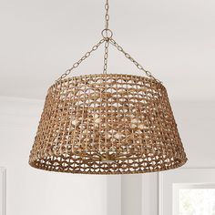 a light fixture hanging from the ceiling in a room with white walls and flooring