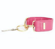 a pink leather dog collar with gold hardware