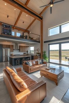 a living room filled with furniture and a large open floor plan in front of a sliding glass door