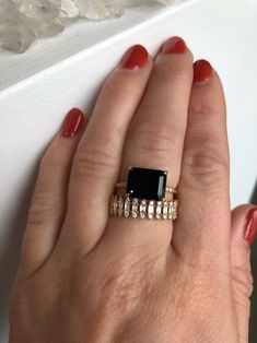 Spin off of our best-selling Onyx Ring, this 3.8ct emerald cut Black Onyx is set horizontally for a more unique feel. Set into our signature claw prongs. Subtle, quarter band Diamonds, 0.08ct. Treat with love due to the center stone softness. Band width, 1.5mm Can't wait? Check out our Ready To Ship pieces or send us a message! Luxury Gemstone Stackable Rings For Formal Occasions, Luxury Rings With Center Stone For Party, Elegant Stackable Black Rings, Modern Gemstone Party Rings, Elegant Black Stackable Rings, Elegant Emerald Ring For Wedding, Modern Emerald Cut Stackable Rings For Formal Occasions, Luxury Baguette Cut Stackable Rings For Formal Occasion, Luxury Baguette Cut Stackable Rings For Formal Events