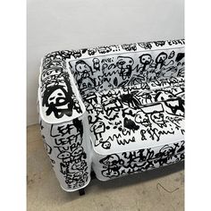 a black and white couch covered in graffiti