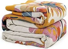 three blankets stacked on top of each other with different colors and patterns in the background