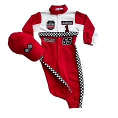 a red and white race car onesie, hat and mitt are laying next to each other