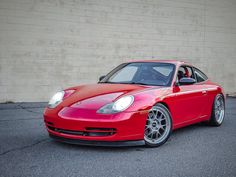 a red sports car parked in front of a building