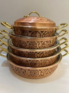 a stack of metal dishes sitting on top of each other