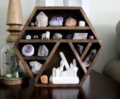 a wooden shelf filled with rocks and crystals