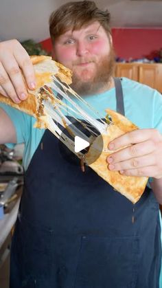 a man holding a large piece of food in his hands