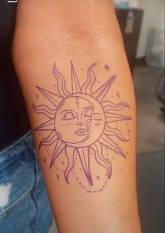 a woman's arm with a sun tattoo on it