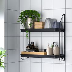 two metal shelves with plants and toiletries on them against a white tiled bathroom wall