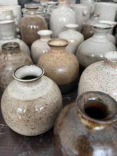 many different vases are lined up on the table