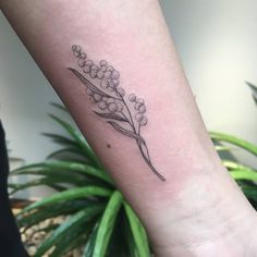 a small flower tattoo on the wrist