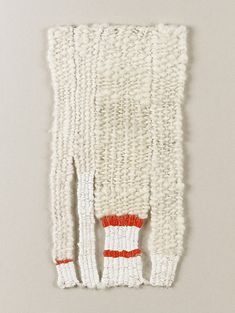 a piece of white knitted material with red and white stripes on the bottom half