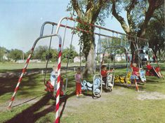 children are playing in the park on swings