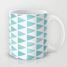 a white and blue coffee mug with an abstract pattern on the inside, sitting on a table