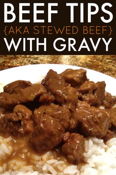 beef tips with gravy served over rice on a plate