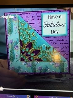 someone is holding up a card that says have a fabulous day on the computer screen