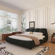 a large bed sitting in the middle of a living room next to a tall window