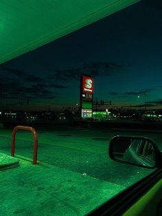 an empty gas station at night with the lights on