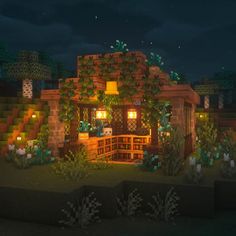 a small house in the middle of a forest at night with lights on and plants growing all around