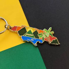 a keychain with the shape of a map and palm trees