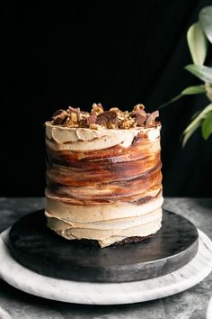 there is a cake that has been frosted with icing and nuts on it