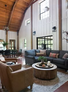 a living room with couches and chairs in it