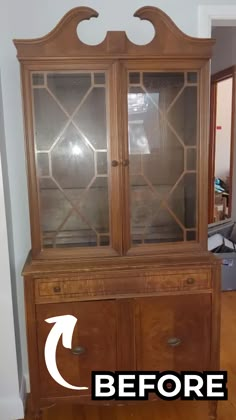 an old wooden china cabinet with glass doors before and after remodeling in the living room