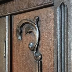 a close up of a door handle on a wooden door