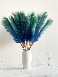 a vase filled with feathers on top of a table