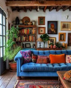 a living room filled with furniture and lots of books