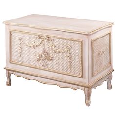 a white chest with gold trimmings on the front and sides, sitting against a white background