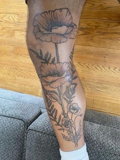 a person with a flower tattoo on their leg