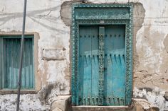 an old building with a blue door and window