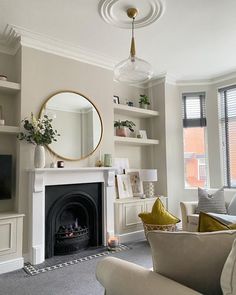 a living room filled with furniture and a fire place