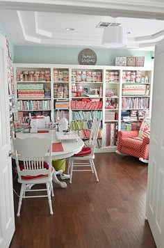 a room with many bookshelves and chairs in it