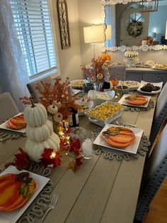 a dining room table set for thanksgiving dinner