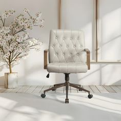 a white office chair sitting in front of a vase with flowers on it and a mirror behind it