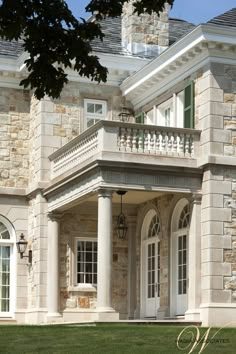 a large stone house with columns and windows