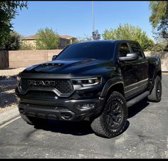 a black truck is parked in the parking lot