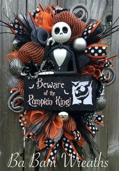 a halloween wreath that says beware of the pumpkin king with a skeleton on it