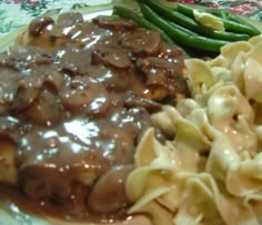 a plate with pasta, green beans and mushroom gravy