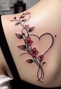 a woman's back with flowers and leaves on it