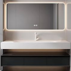 a bathroom with a sink, mirror and lights on the wall above it's counter