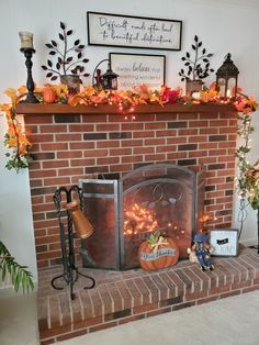 a fire place with a brick fireplace decorated for halloween and decorations on the mantel