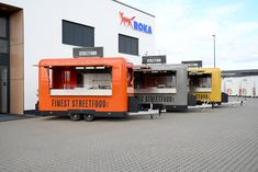 an orange and black food truck parked in front of a building with the words finest street food written on it